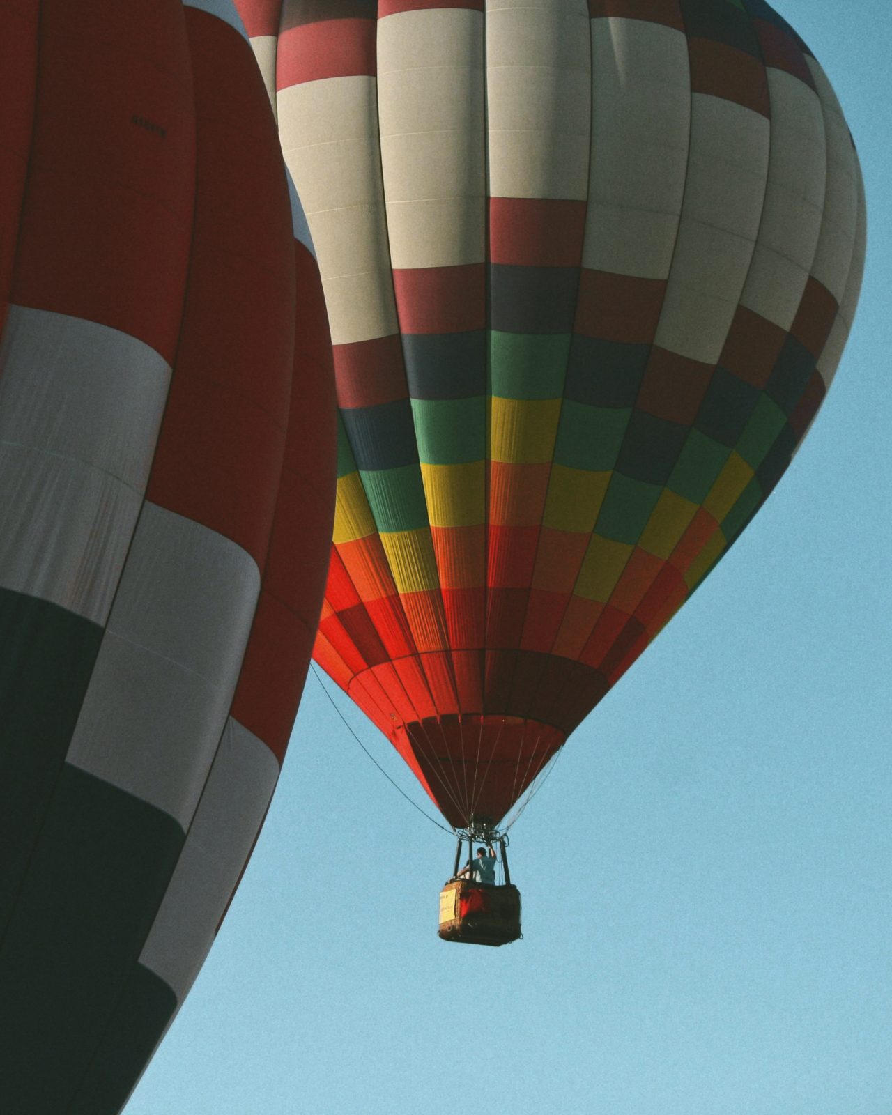 hot air balloon passes in front of another