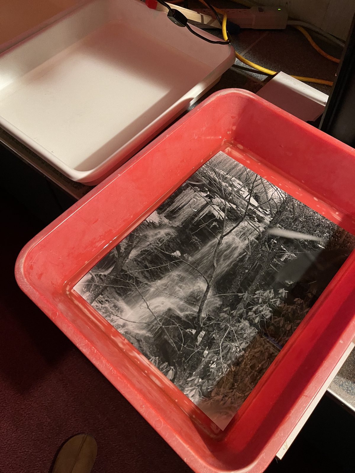 An 11x14 print of a waterfall is soaking.