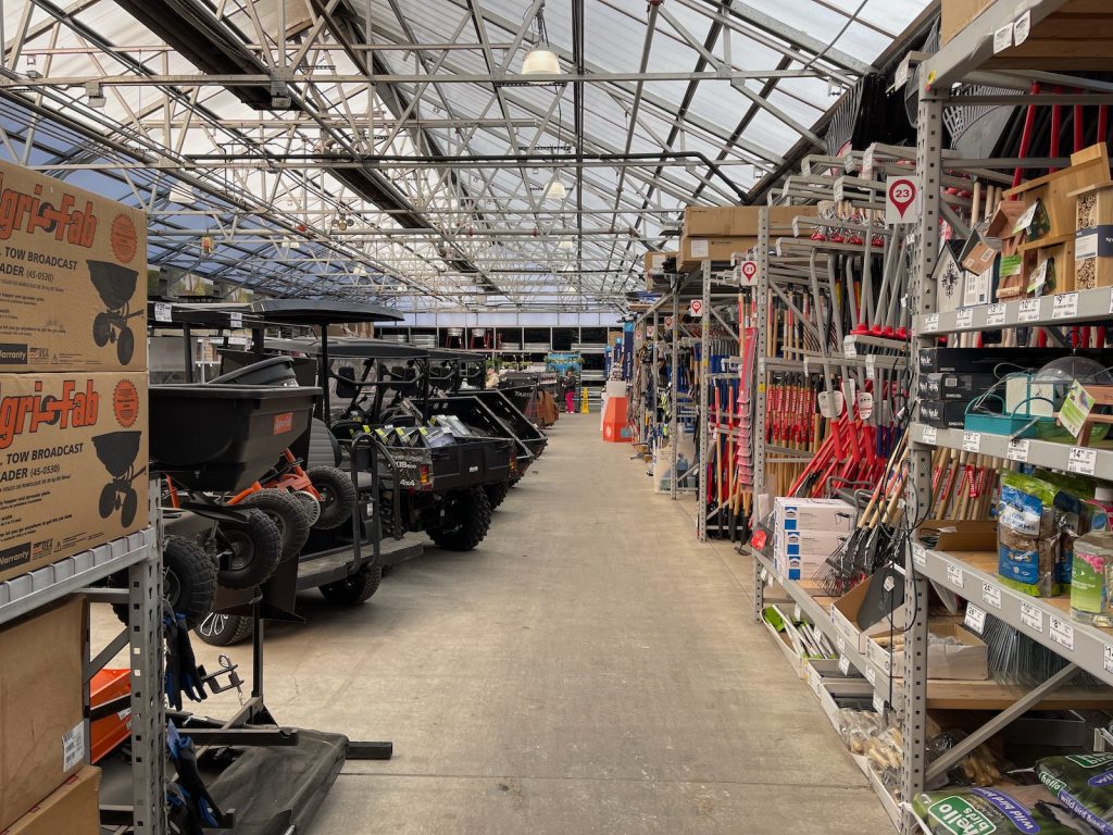 A garden center, full of ATVs, shovels, birdseed, outdoor grills, and plants, is full of springtime potential.