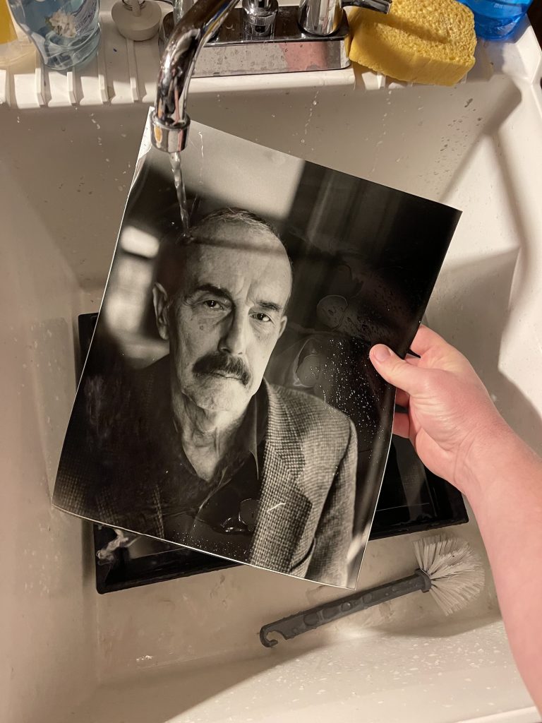 A photo being washed in a sink.