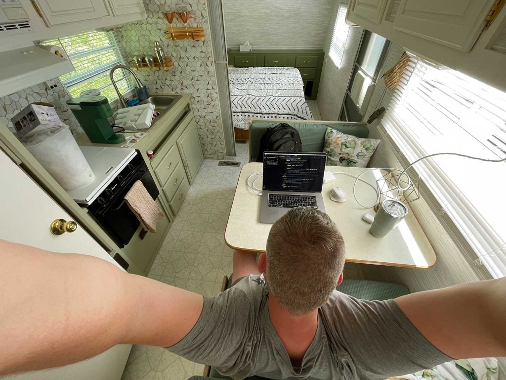 An overhead photograph of me sitting at the dinette in our camper.