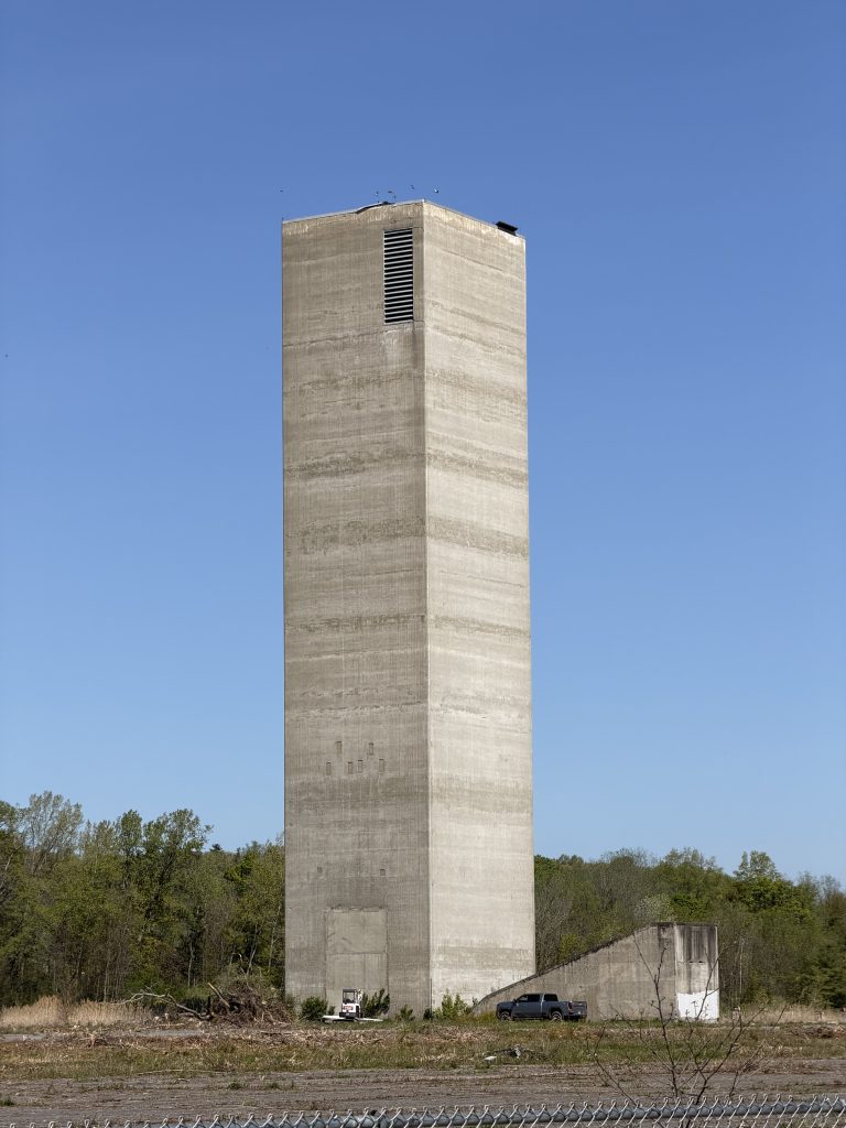 The taller stack house with a relatively new pickup truck near it.